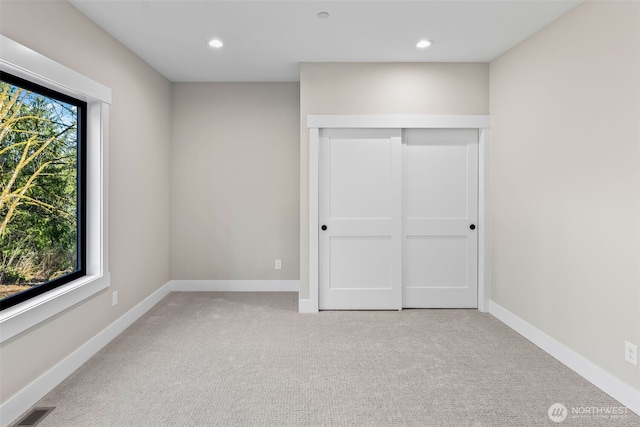 unfurnished bedroom with recessed lighting, visible vents, baseboards, and carpet flooring