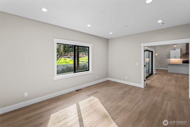 interior space with recessed lighting, visible vents, light wood-type flooring, and baseboards