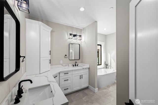 bathroom with a soaking tub, recessed lighting, and vanity