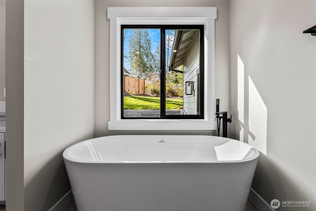 full bath featuring a soaking tub