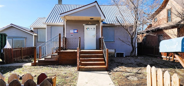 bungalow featuring fence and metal roof