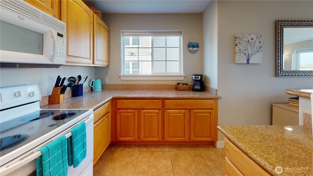 kitchen featuring light tile patterned floors and white appliances