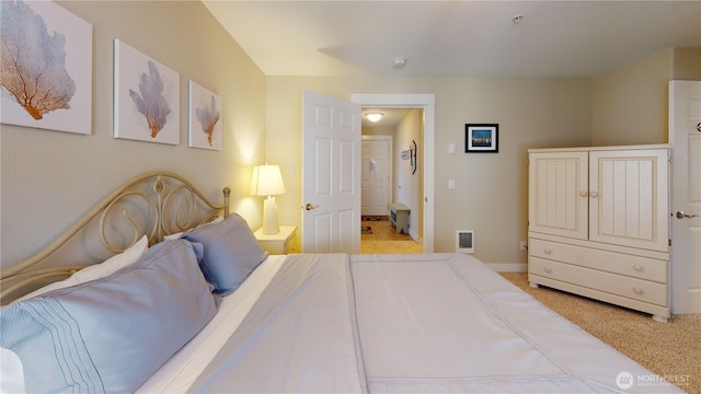 bedroom with carpet flooring, connected bathroom, and baseboards