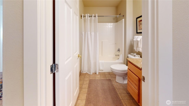 bathroom featuring tile patterned floors, toilet, vanity, and shower / tub combo with curtain