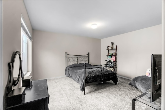 bedroom featuring carpet floors and baseboards