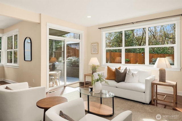 living room featuring recessed lighting, visible vents, baseboards, and wood finished floors