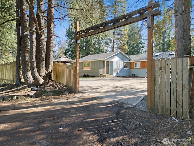 exterior space featuring driveway and fence