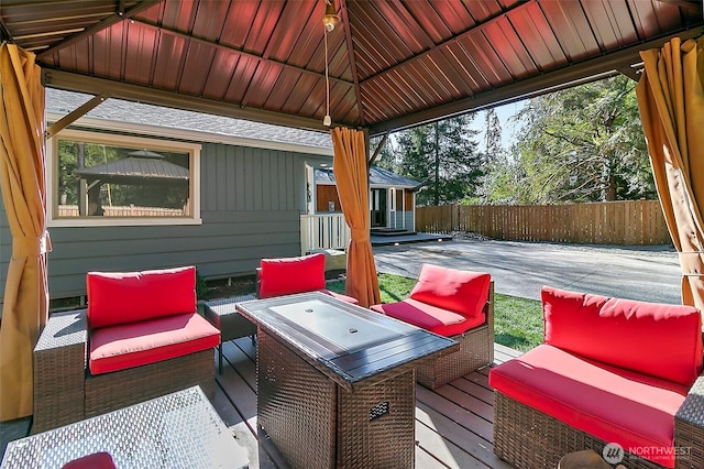 wooden deck with fence, an outdoor hangout area, and a gazebo