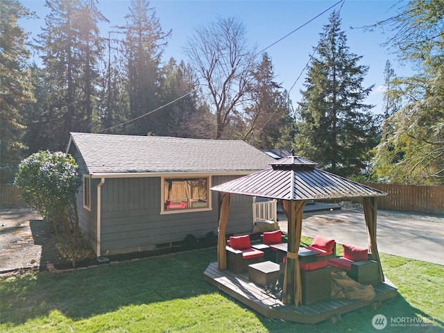 exterior space featuring a gazebo, a yard, and fence