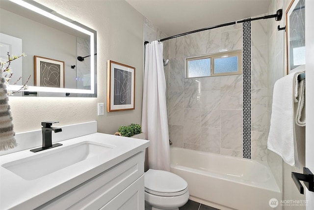 bathroom with toilet, vanity, shower / bath combination with curtain, and a textured wall