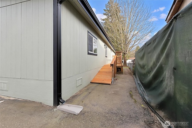 view of home's exterior with crawl space and fence