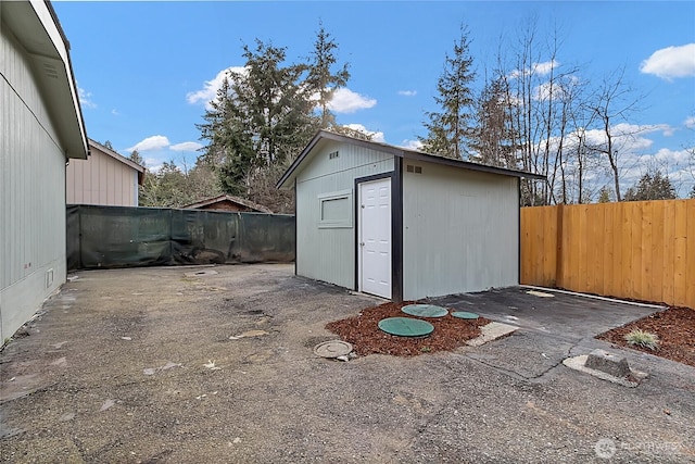 view of outdoor structure with an outbuilding and a fenced backyard