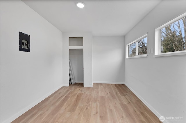 unfurnished bedroom featuring light wood-style flooring and baseboards