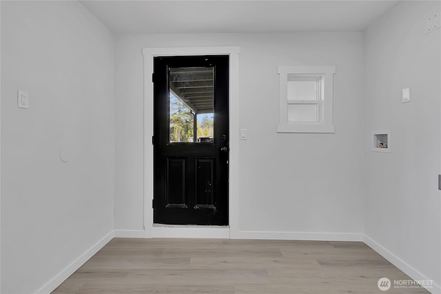 foyer with light wood-style floors and baseboards