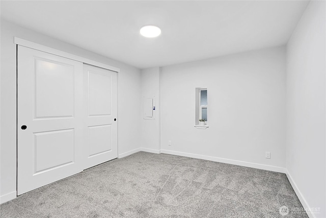 empty room with carpet flooring and baseboards