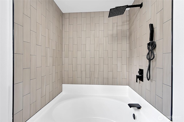 bathroom featuring a washtub and tiled shower