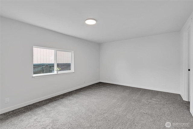 carpeted spare room with baseboards