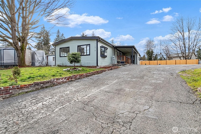 manufactured / mobile home featuring a front yard, crawl space, and fence