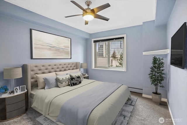 carpeted bedroom with ceiling fan, a baseboard heating unit, and baseboards