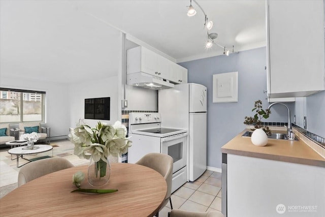 kitchen featuring white range with electric cooktop, light tile patterned flooring, a sink, light countertops, and white cabinetry