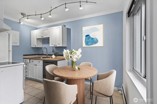 kitchen featuring ornamental molding, a sink, white cabinetry, freestanding refrigerator, and dishwashing machine