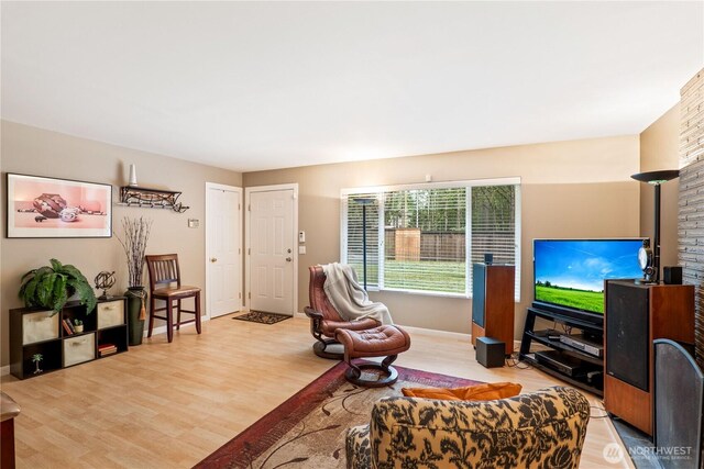 living room featuring baseboards and light wood finished floors