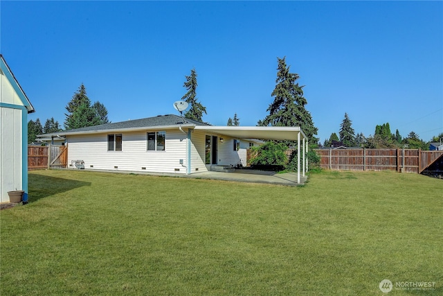 back of house with a yard, a patio, and a fenced backyard