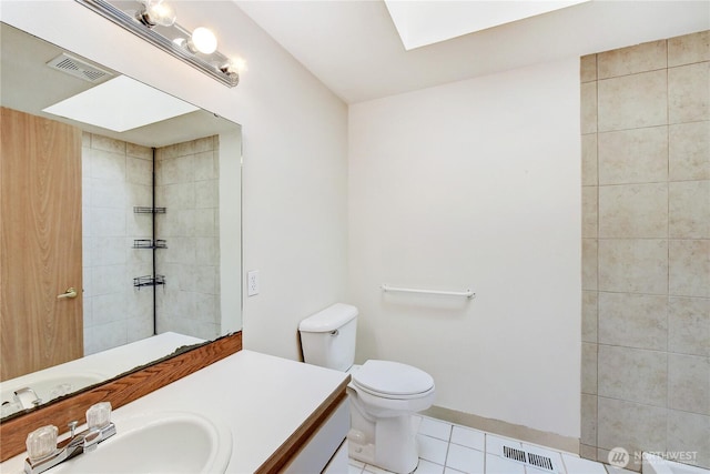 full bathroom with vanity, tile patterned floors, toilet, and visible vents