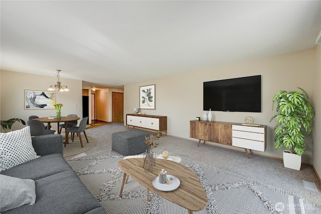 living room with a notable chandelier, carpet, and baseboards