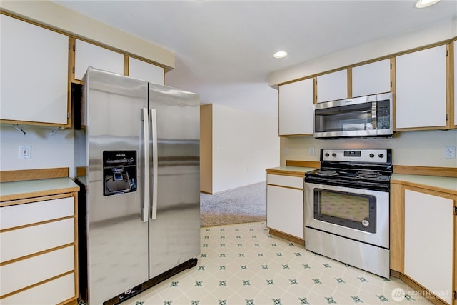 kitchen featuring recessed lighting, appliances with stainless steel finishes, and light countertops