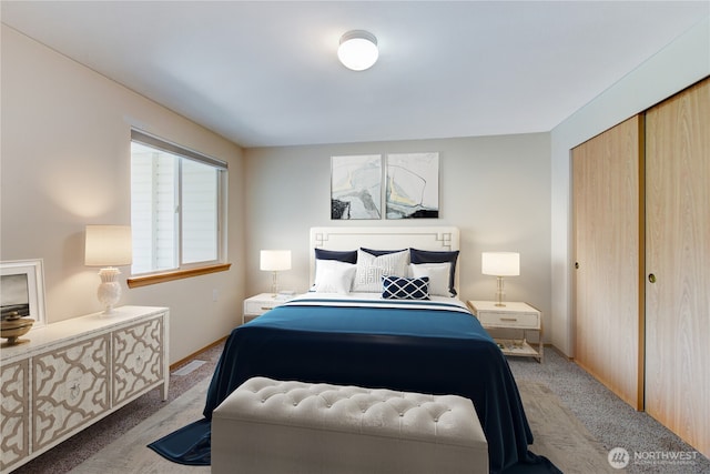 carpeted bedroom with a closet and visible vents