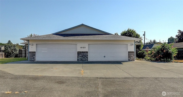 detached garage featuring fence