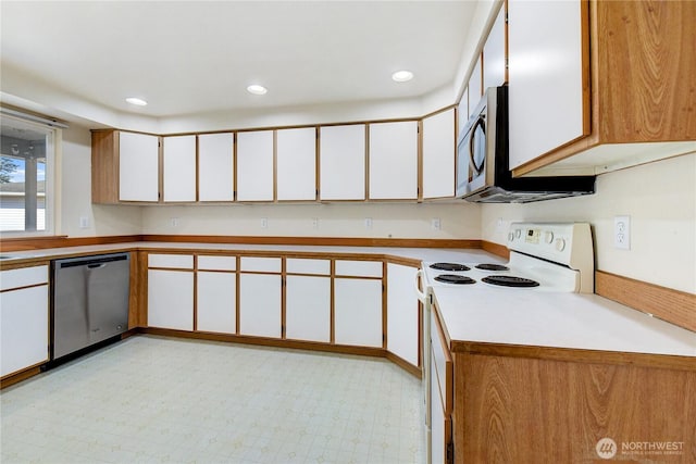 kitchen featuring recessed lighting, appliances with stainless steel finishes, white cabinets, light countertops, and light floors