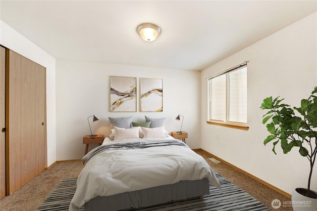 bedroom with baseboards, carpet floors, visible vents, and a closet