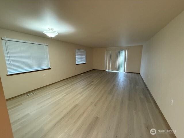 spare room with visible vents and wood finished floors