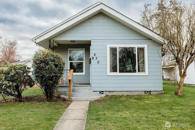 bungalow with covered porch, a front lawn, and crawl space