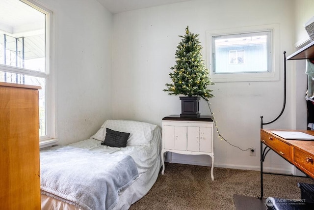 carpeted bedroom featuring baseboards