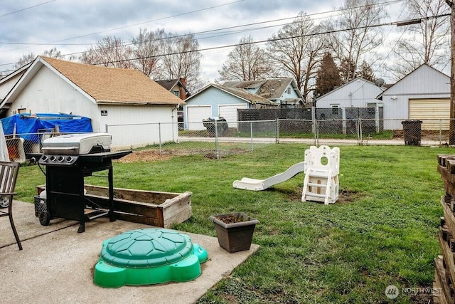 view of yard with a garage and fence