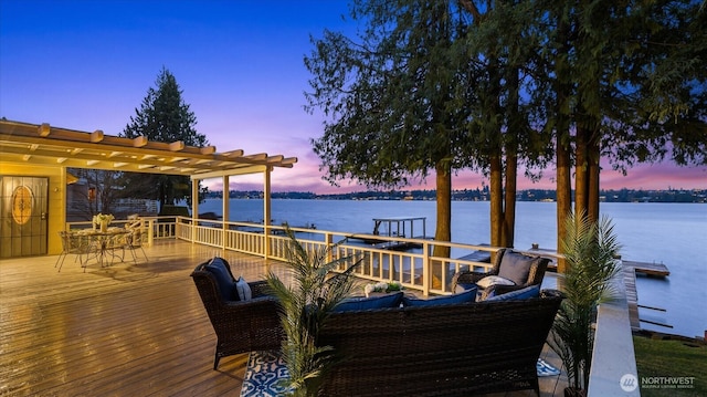 view of dock with a deck with water view and a pergola