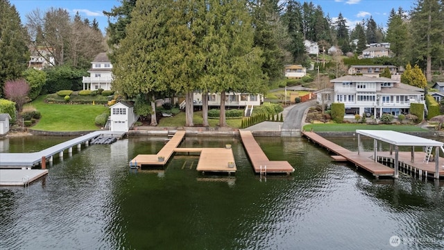 view of dock featuring a yard and a water view