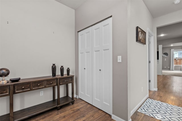 interior space with baseboards and wood-type flooring