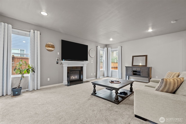 carpeted living room with a fireplace with flush hearth, recessed lighting, and baseboards