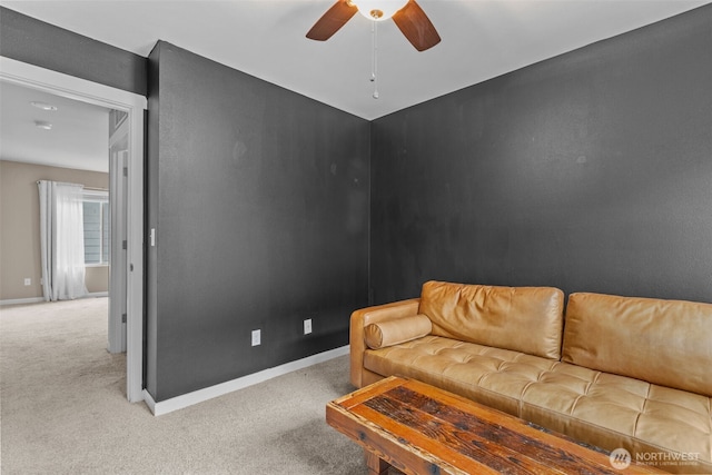 living room featuring ceiling fan, baseboards, and carpet floors