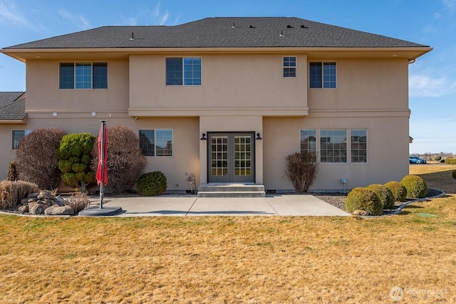 back of property featuring french doors, a patio, a yard, and stucco siding