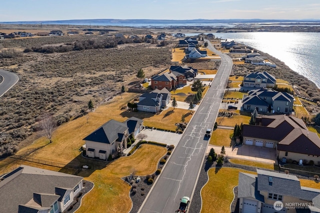 bird's eye view with a residential view and a water view