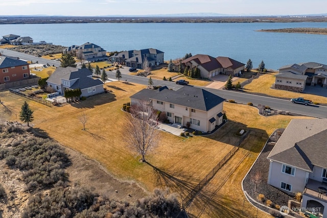 drone / aerial view with a residential view and a water view