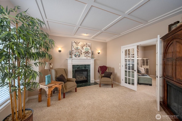 living area with baseboards, light colored carpet, a premium fireplace, french doors, and coffered ceiling