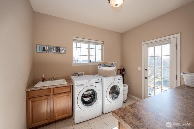 washroom with a sink, cabinet space, independent washer and dryer, and light tile patterned flooring