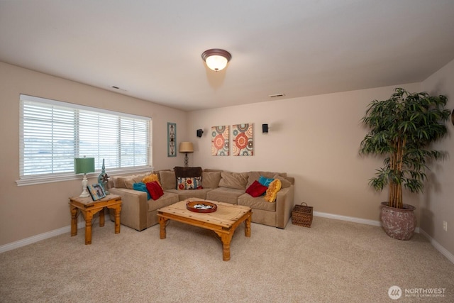 carpeted living area featuring visible vents and baseboards