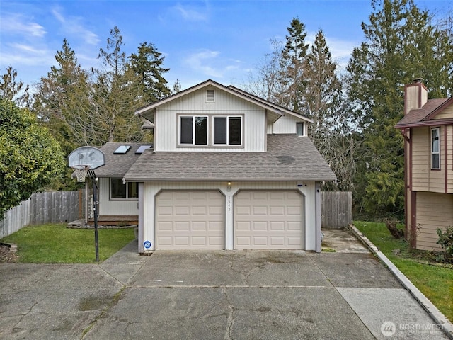 view of front facade featuring driveway, a shingled roof, a garage, and fence